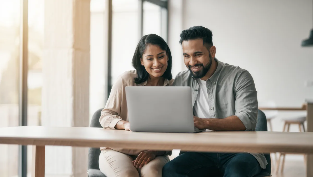 Parents reading a school website together on a laptop at home while comparing fees